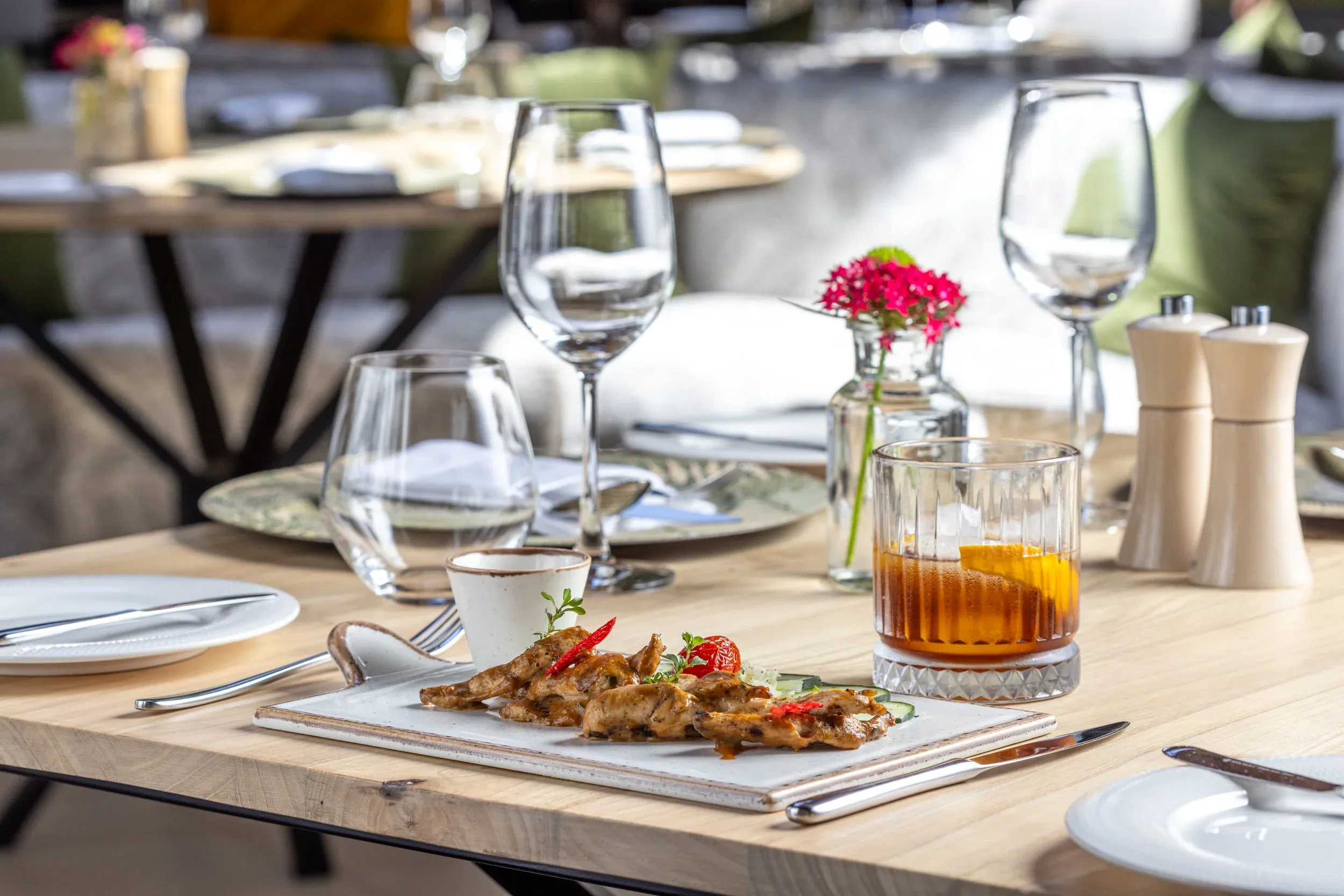 A plated main course served on a table set for dinner at Royal 58, Muthaiga