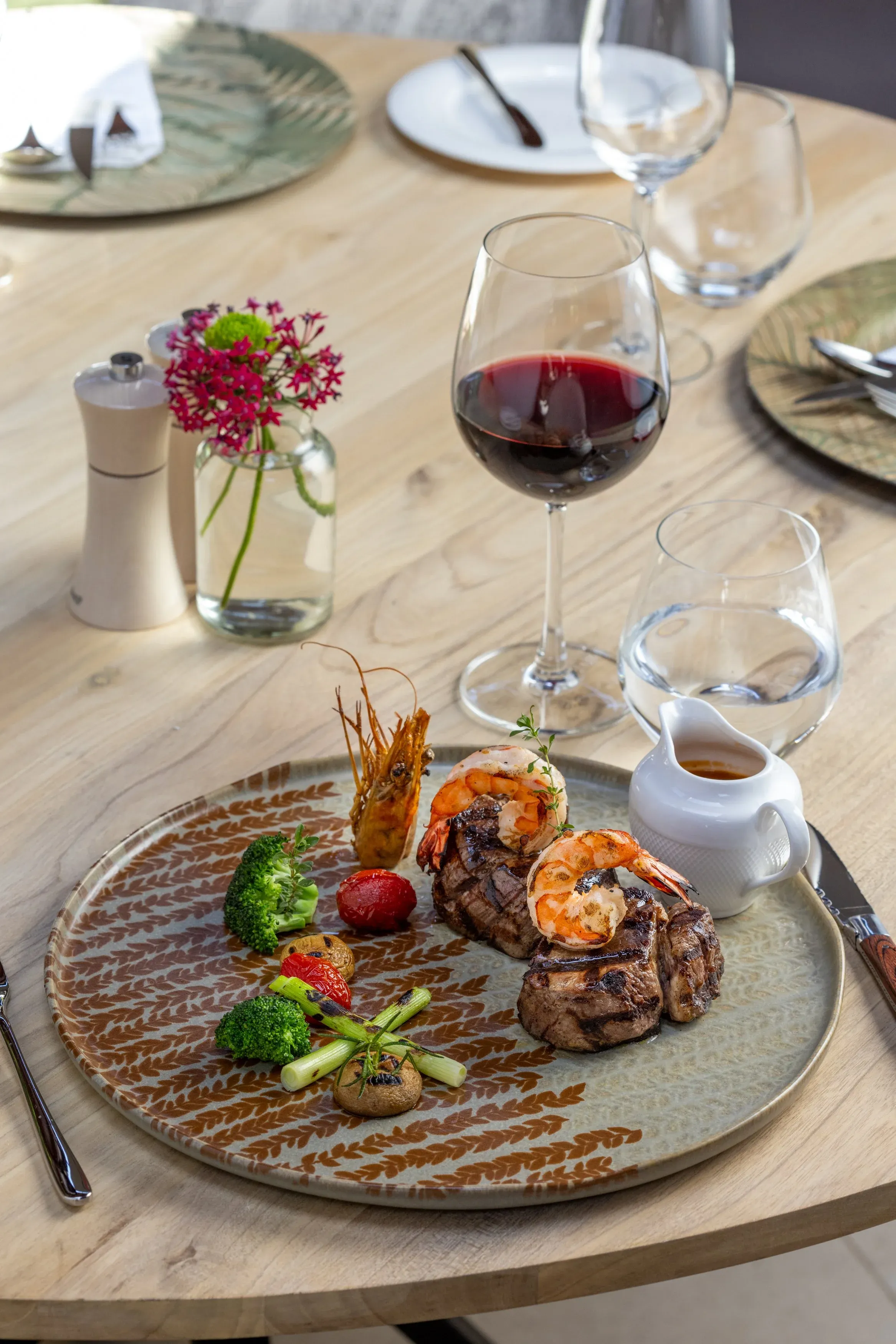 Surf and turf with grilled prawns and steak, served with red wine at Royal 58