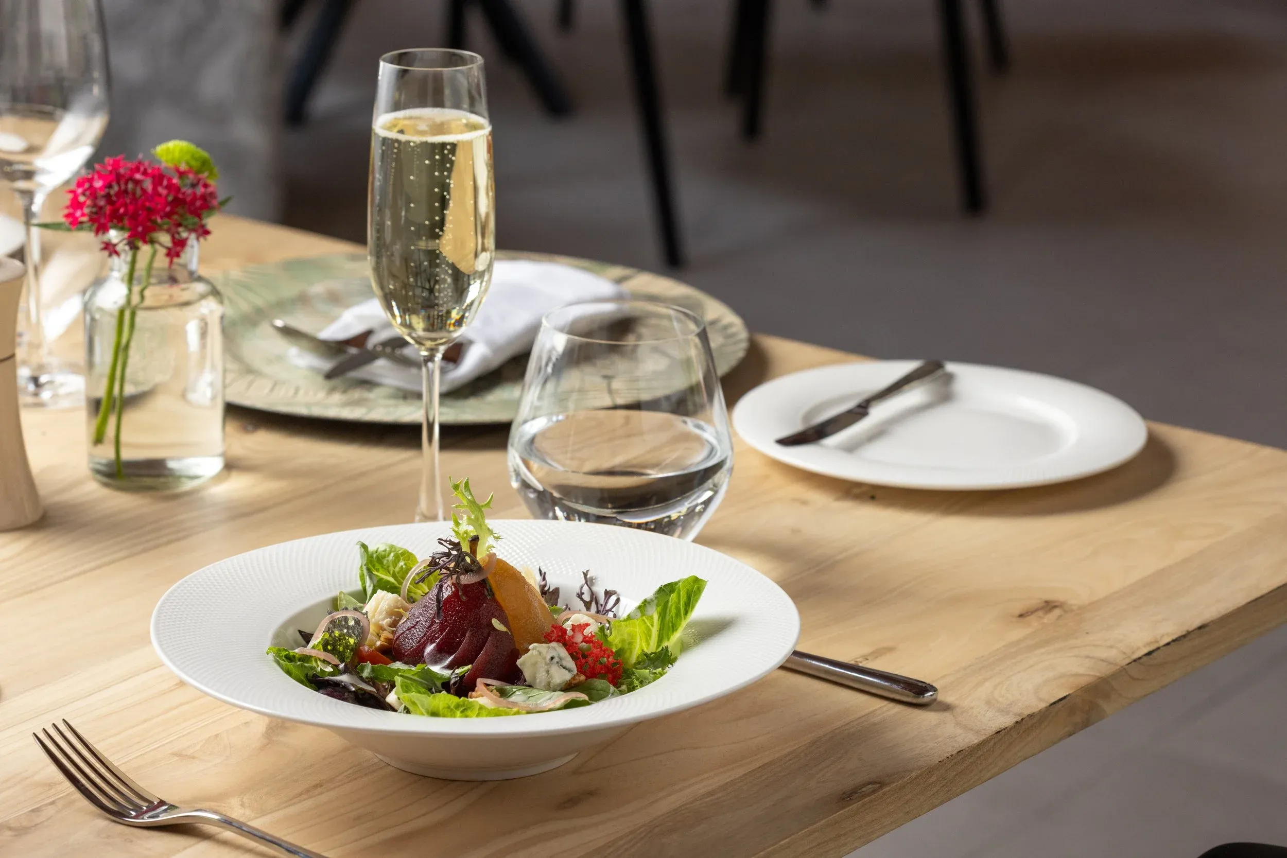 Beetroot and leaf salad served with a glass of champagne